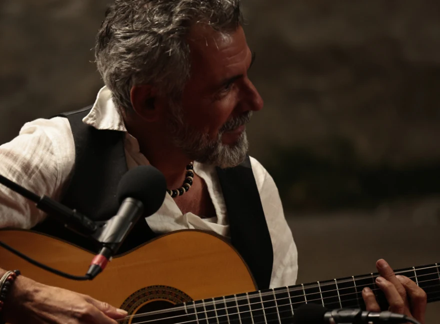 Pascal Alba performing on guitar
